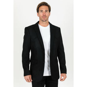 Man wearing a black blazer over a white shirt on a white background